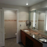 Installed heated floor, dual sinks, counters, custom tile work, and added new lighting.